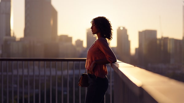 Portrait of a woman silhouetted against a cityscape