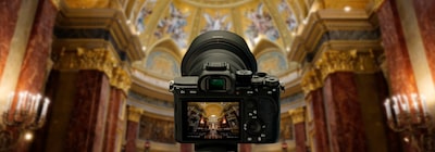 View of the camera from the back, with the out-of-focus interior of a church in the background