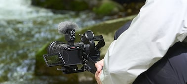 Usage image showing camera mounted on a gimbal with a river in the background